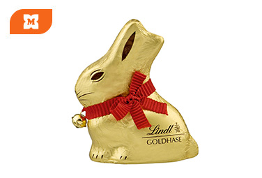 Zlatý čokoládový zajačik Lindt Goldhase s červenou stužkou a zvončekom, balený v zlatej fólii.